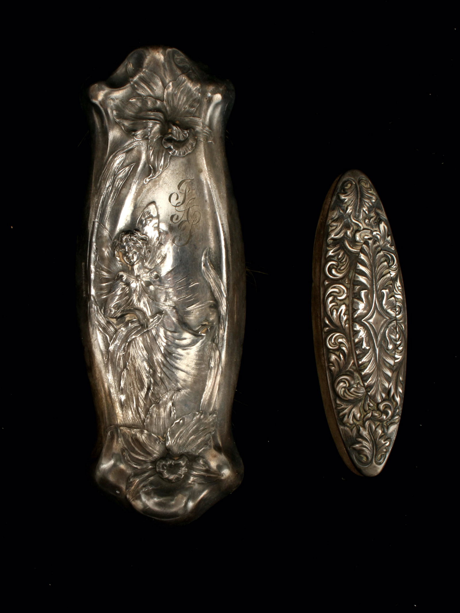 VANITY SET: Clothes brush by Hope Silver Co. engraved with the initials "J A T" next to a pixie standing among daffodils and sterling nail buffer marked "Bailey, Banks & Biddle" 7 1/4"