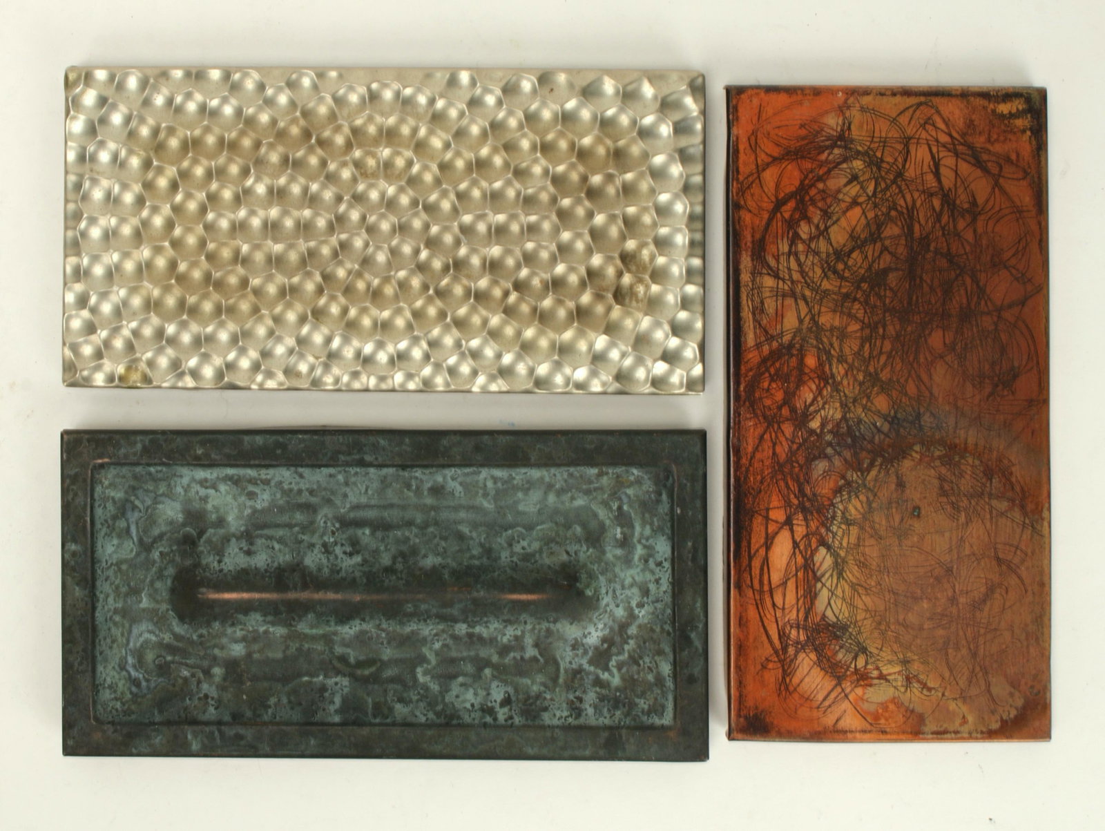 MCM 2 COPPER TILES 1 SILVER TONED METAL TILE: Silver toned metal in a hammered finish. One of the copper tiles is in a verdigris patina, the other is in sgraffito. Mid century. Taking the classic subway tile proportion in a brand new direction. 6