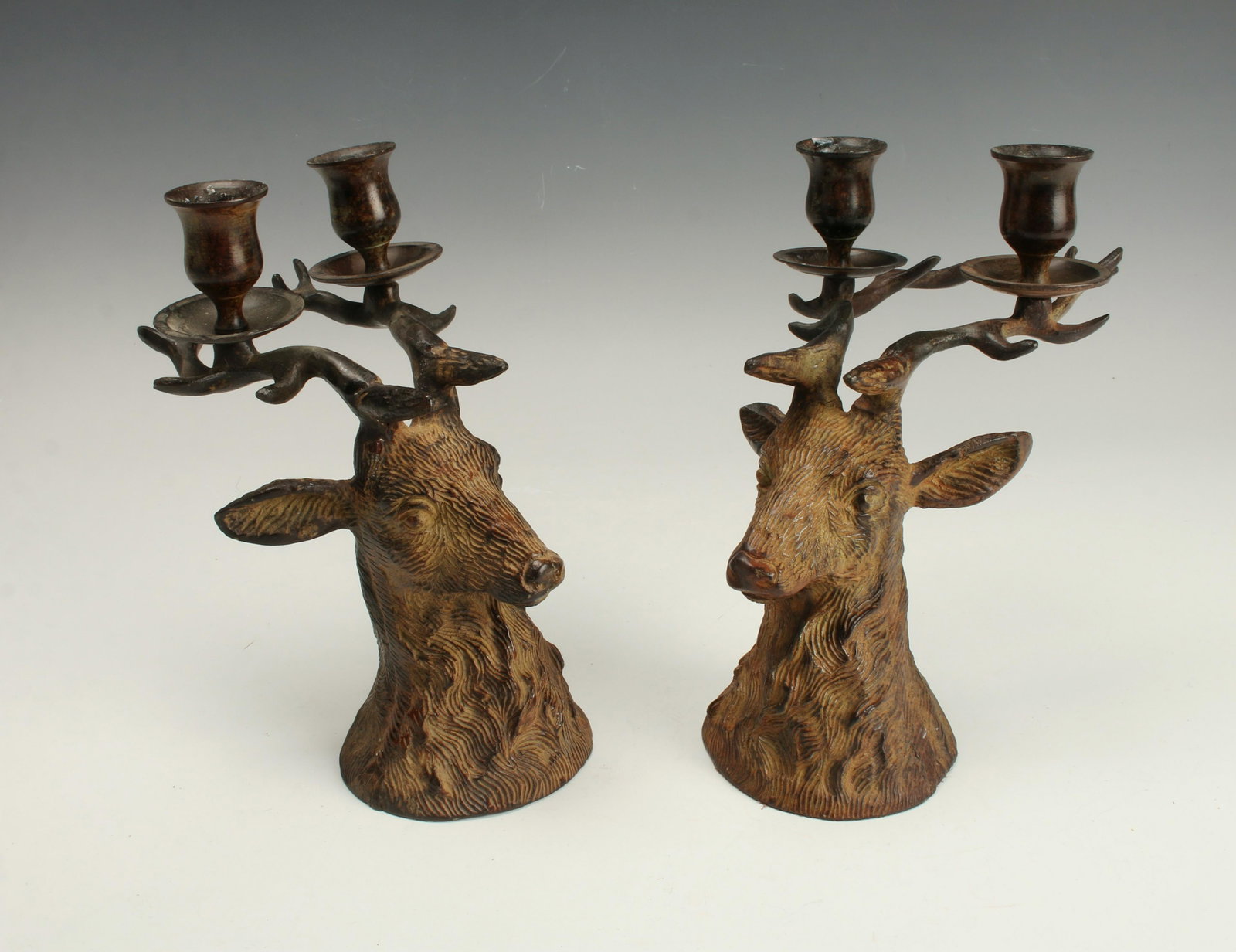 PAIR OF STAG 2 CANDLE CANDELABRA: Deer form candelabra, each holding two candles mounted on the antlers. In dark brown and ochre with textured fur. 8 1/2 x 5" $40 - $80 Please contact us for high resolution images of this l