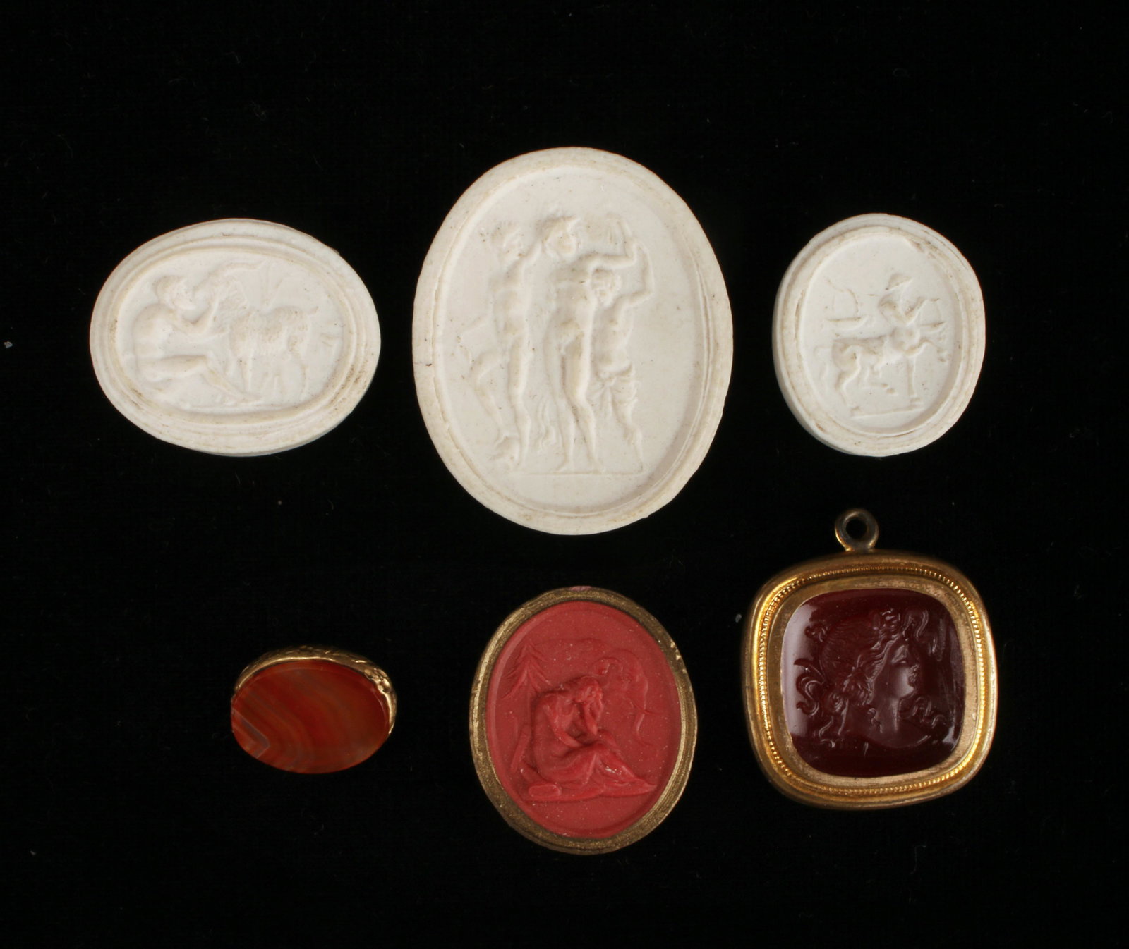 19TH C GRAND TOUR INTAGLIOS PLASTER CARNELIAN: Three grand tour plaster unset intaglio. Largest 1 1/2" is three figures, one is a bearded man with goat, one with a centaur. Carnelian framed woman in profile. Red intaglio of a woman seated in 