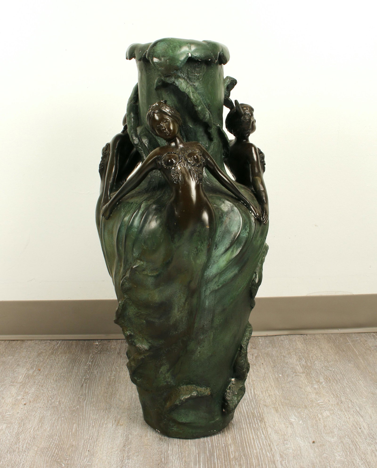 BRONZE ART NOUVEAU STYLE VASE: Three graces surround the vase with their hands joined together to form triangular elements. Wave patterns. Dark verdigris patina. Unsigned. 27" x 12" $100 - $200 Please contact us fo