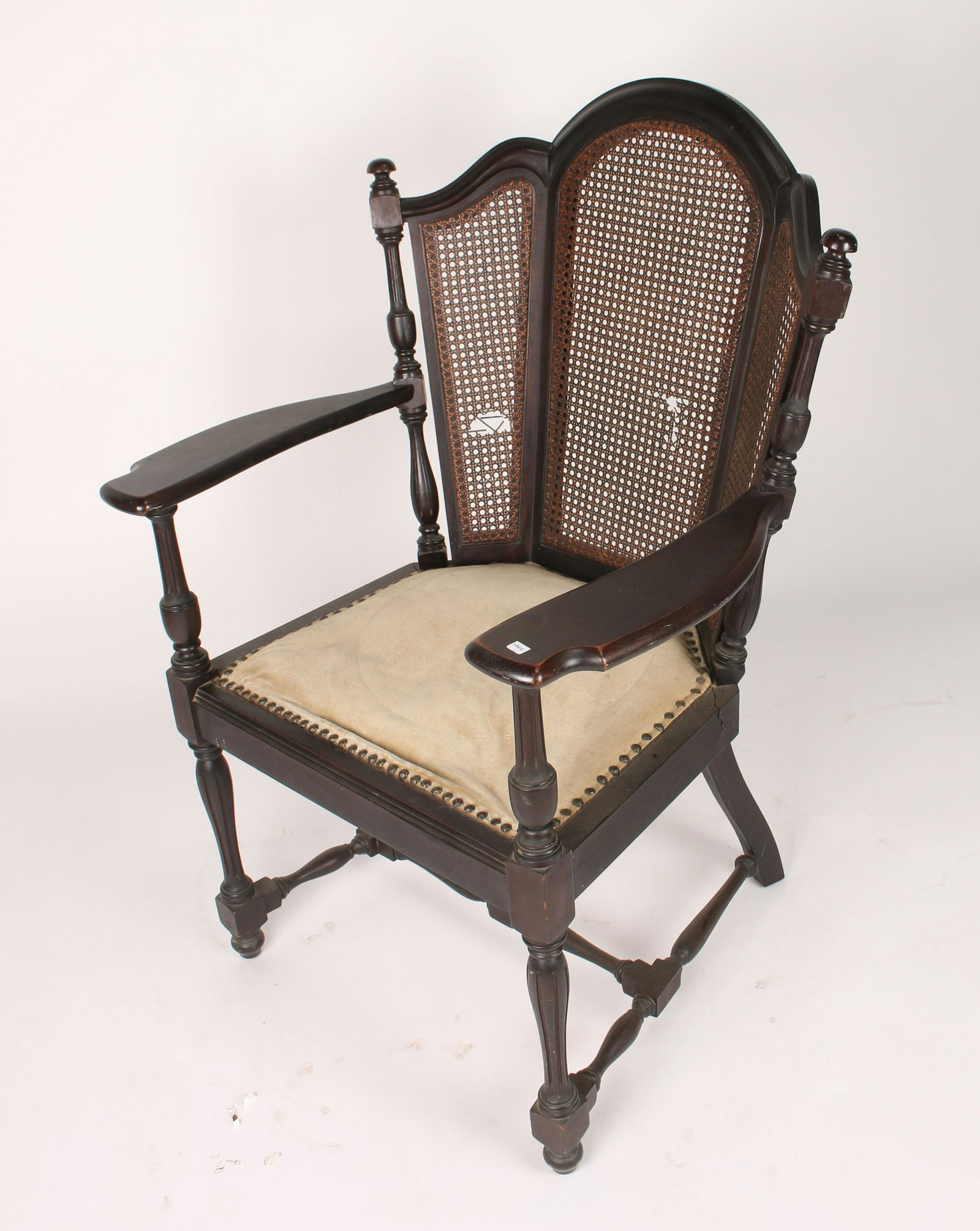 VICTORIAN CANE BACK LIBRARY ARM CHAIR: Mahogany with elaborate turnings and a tri-part caned back. With wide arm rests and an upholstered seat. 26 1/2" X 25" X 39 1/2" $40 - $80 Please contact us for high resolution i