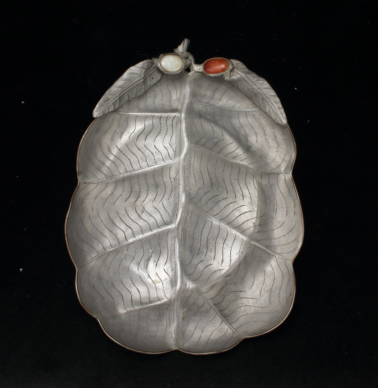 CHINESE PEWTER LEAF FORM SERVING DISH: Shaped as a leaf with jade and carnelian insets at the stem. Incised with leaf veins. On low oval foot. 7 1/2" X 5 1/4" $20 - $40 Please contact us for high resolution images of this
