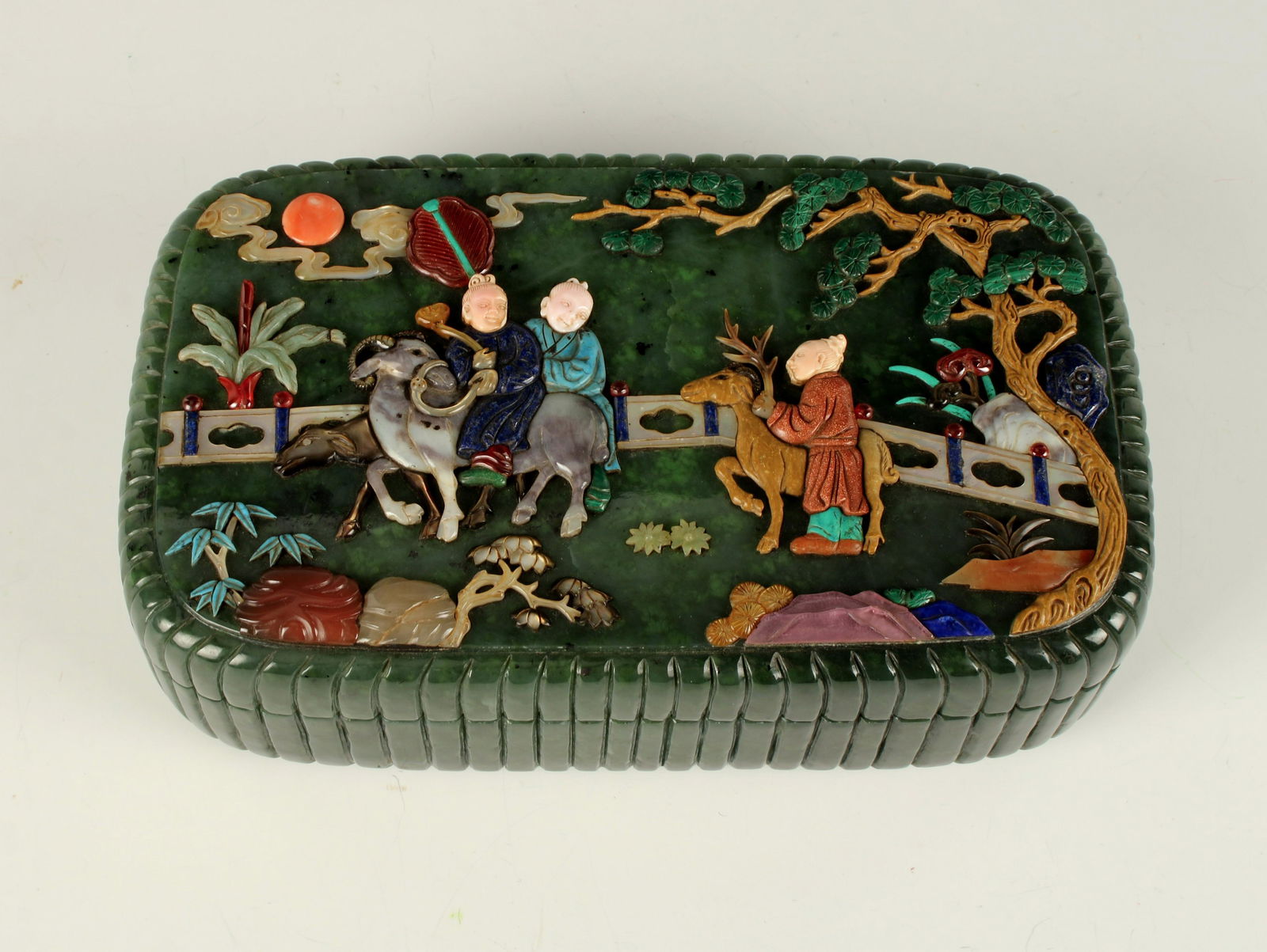 LARGE JADE BOX WITH APPLIED HARD STONE SCENE: Immortals are in a garden. Malachite, lapis, turquoise, gold stone, mother of pearl, and other various stones are carved and incised. 3.8lbs.. Provenance: