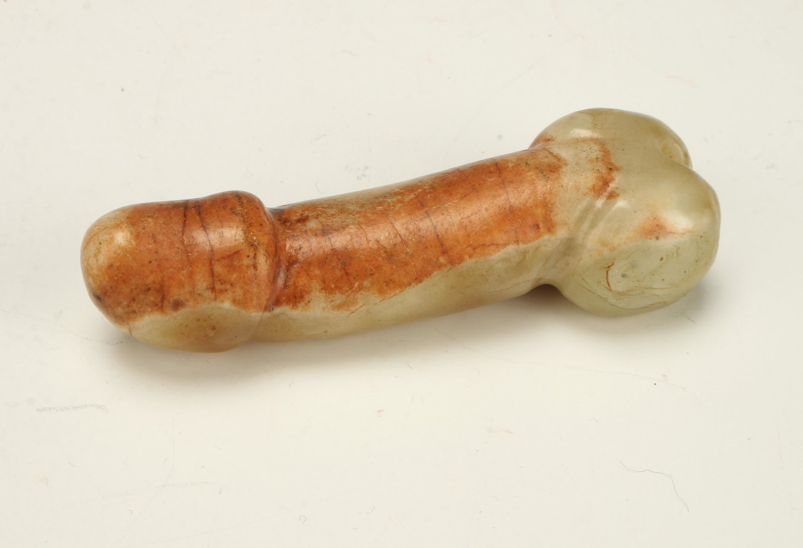 CARVED JADE GOOD LUCK PHALLUS: Jade coloration is in greens and oranges with veining. 3 1/4" $100 - $200 Please contact us for high resolution images of this lot. Shipping: We are able to pa