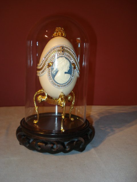 Jewelry Display Casket: An unusual jewelry display casket in the form of a wedgwood or jasperware and pearl decorated egg within a dome covered display stand.
