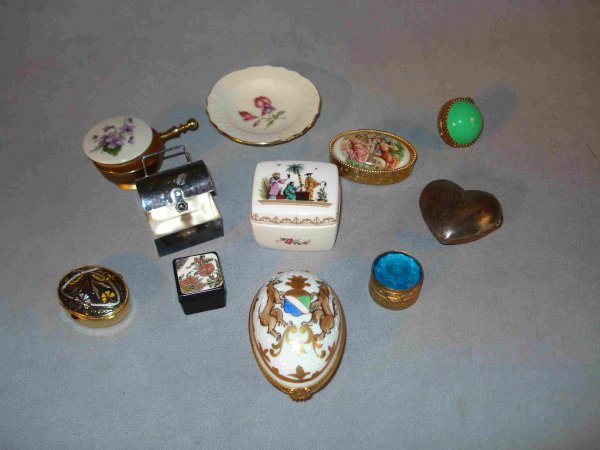 Assorted enamel pill boxes or patch boxes: A collection of 10 assorted enamel, porcelain, and silver pill boxes and objects of vertu, including a hand painted example by Limoges and one marked Royal Worcester.