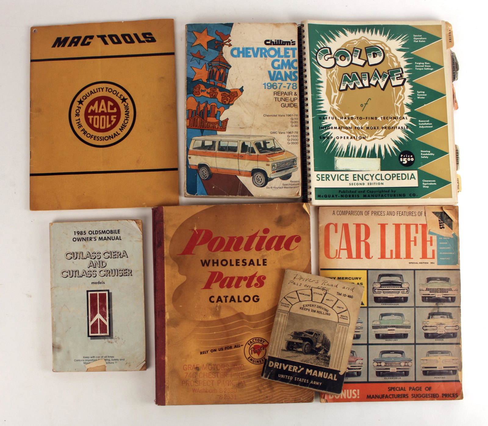 VINTAGE CAR BOOK & MANUAL LOT: 1942 US Army Driver's Manual, GM Van, Pontiac parts, Mac Tools, Car Life, and Gold Mine 1953. 8 1/2" X 11" $40 - $80 Please contact us for high resolution images of this lot. Sh