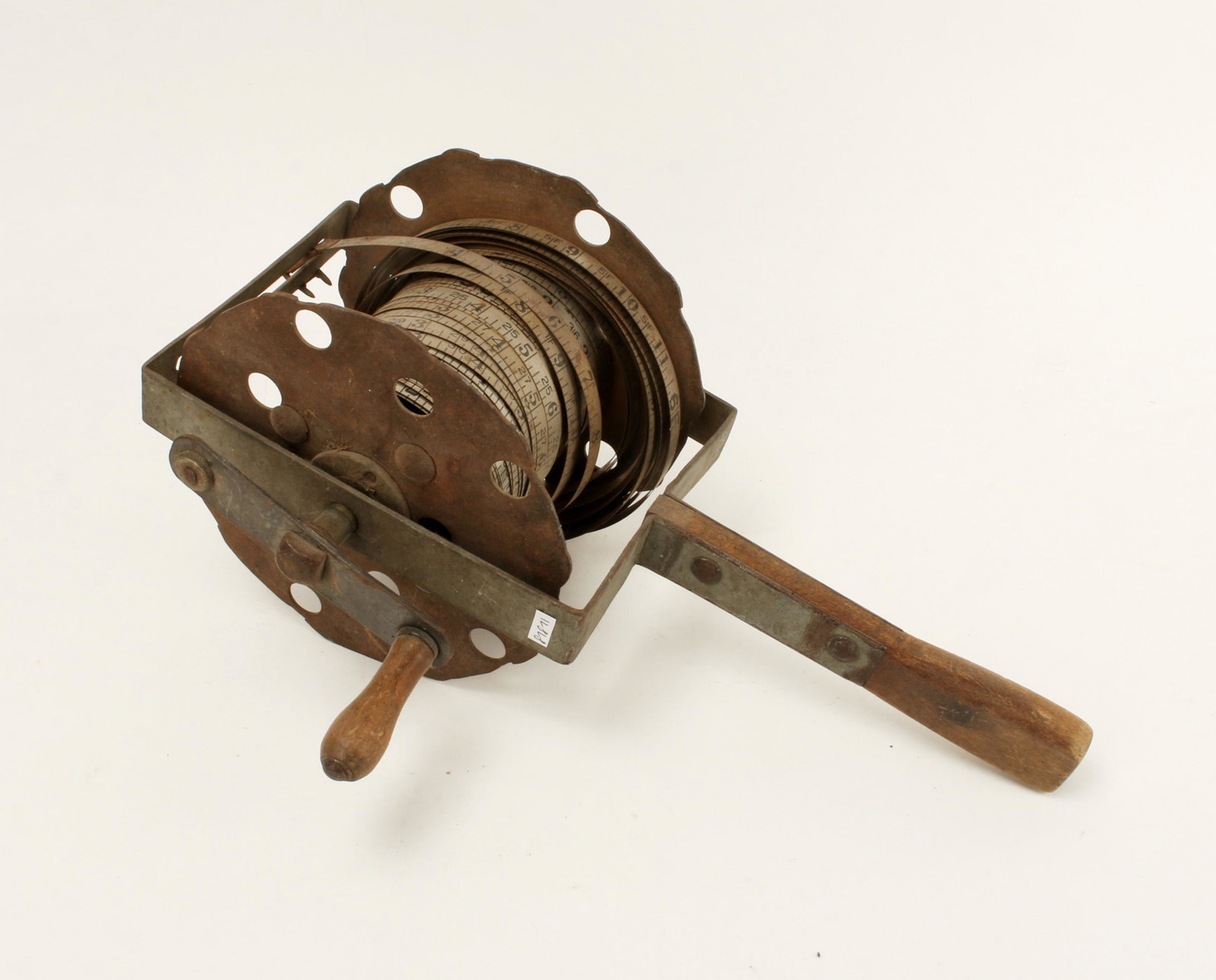 RARE ANTIQUE SURVEYORS MEASURING TAPE REEL: Rare steel and wood surveyor's tape reel. The tape is metal and marked in inches and feet. With well-worn wooden crank and handle. 15" X 9" $100 - $200 Please contact us for high resol