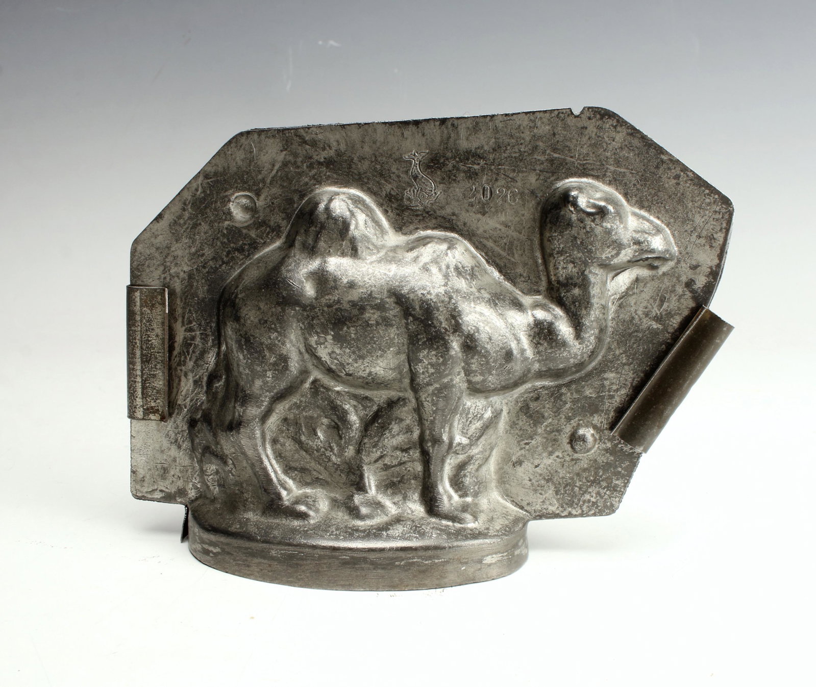 TIN MONGOLIAN CAMEL CANDY CHOCOLATE MOLD: In two pieces with clips to secure it. Open at bottom to pour liquid. 5" x 3 3/4" x 1" $20 - $40 Please contact us for high resolution images of this lot. Shipping: