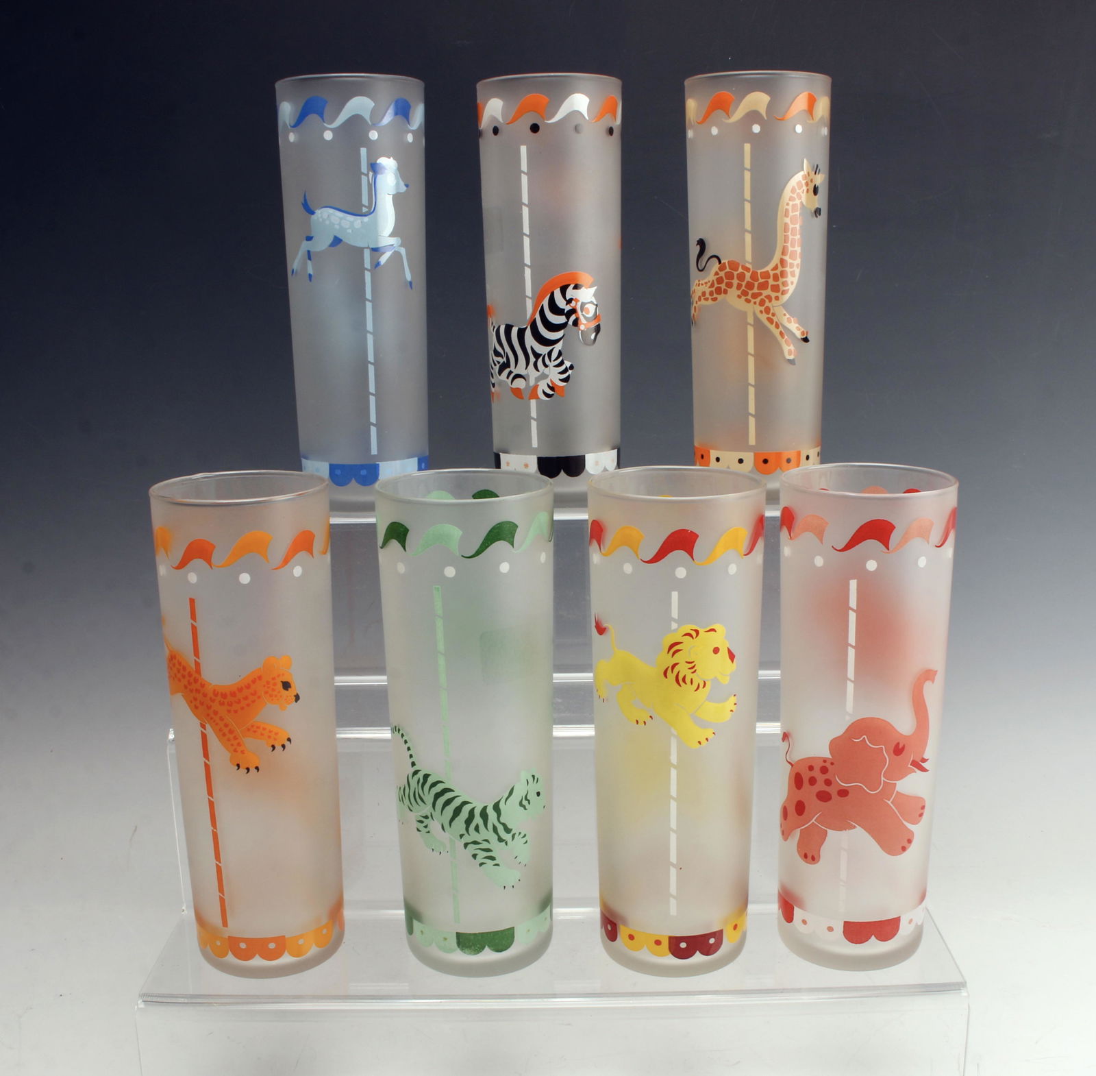 7 VINTAGE LIBBY MERRY-GO-ROUND FROSTED GLASSES: Iced tea/Tom Collins glasses with adorable merry-go-round animals on them in bright colors. Animals are higher or lower on the pole depending on side of cup. Tiger, cheetah, lion, elephant, deer, gira