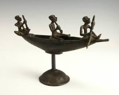 BRONZE BOAT NIGERIA: Bronze Boat NigeriaTwo figures steer a boat while the one in the middle holds a weapon. Raised on