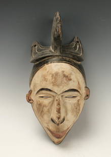 IGBO TRIBE MASK NIGERIA: Igbo Tribe Mask NigeriaWhite face, red lips and ears, black eyebrows, pierced nose. Pierced black headdress. 15 1/2" X 7 1/2" $100 - $200 Shipping: We are able to pack and ship this item