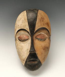 GALOA TRIBAL MASK GABON: Galoa Tribal Mask GabonSlight color difference on both face halves, swath of blue on the side of each eye. 13" X 8" $100 - $200 Shipping: We are able to pack and ship this item to an