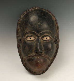 AFRICAN BULU MASK CAMEROON: African Bulu Mask CameroonBlack with white eyes, embellished with five brass tacks. Wrapped raffia frown of a mouth, wide rapped border around mask edge. 15" X 10" $100 - $200 Shipping: We