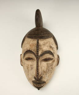 IGBO MASK NIGERIA: Igbo Mask NigeriaWhite face with black headdress and features. Ridge down nose, joined arch brows, and a mouth revealing teeth. 15" X 8" $100 - $200 Shipping: We are able to pack and ship