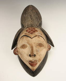 PUNU MASK GABON: Punu Mask GabonTall black headpiece with incised lines. White face with pointed chin. Three dimen