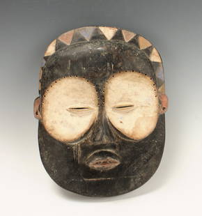 BUNDU MASK CONGO: Bundu Mask CongoBlack painted mask with white eye sockets. Headdress of black triangles alternati