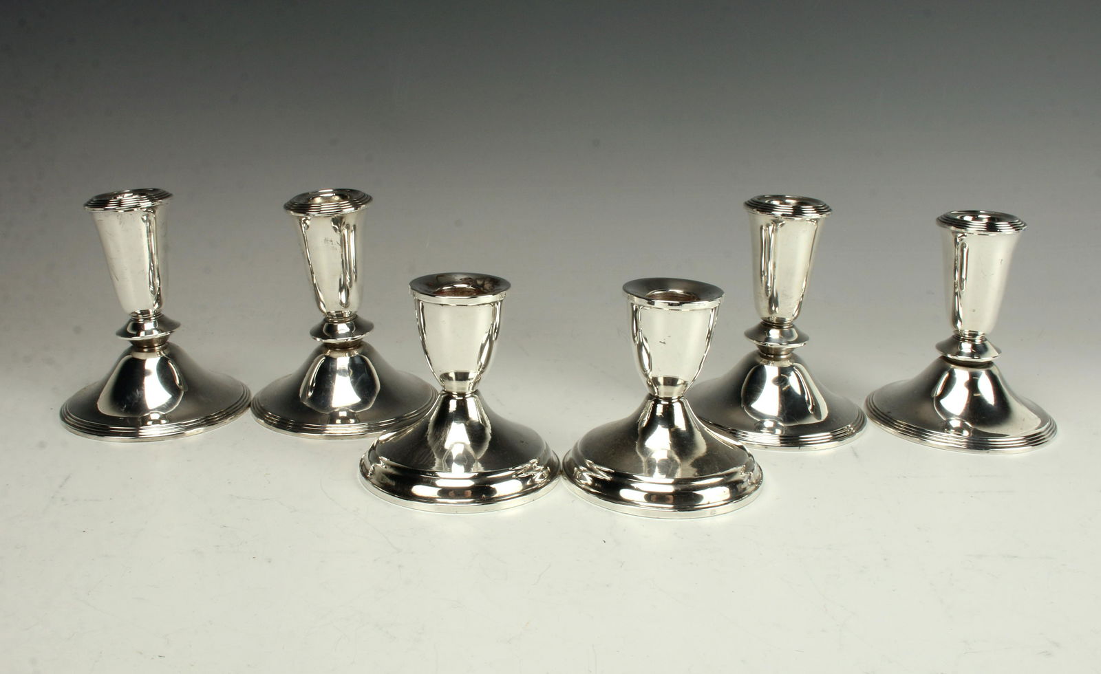 SIX STERLING LOW CANDLESTICKS (1 of 3)