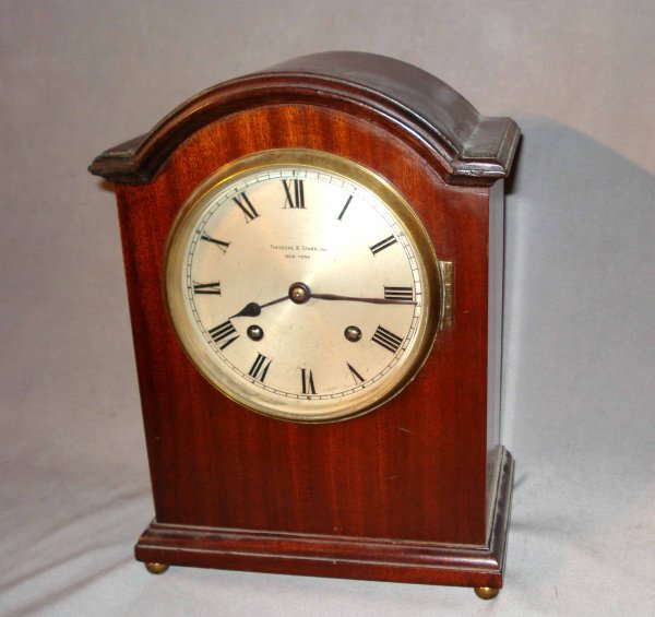 Quarter hour strike mantel clock : A quarter hour striking mahogany mantel clock with an arched top and round silvered and engraved dial probably by the German firm Winterhalter & Hoffmeier. Signed on the dial "Theodore Starr, New York