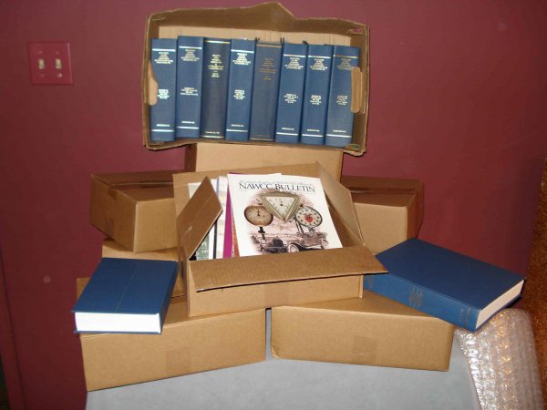 NAWCC Publications: Nine boxes containing publications by NAWCC (National Association of Watch and Clock Collectors) with articles on antique clocks and watches, including hard bound reprinted old back issues.