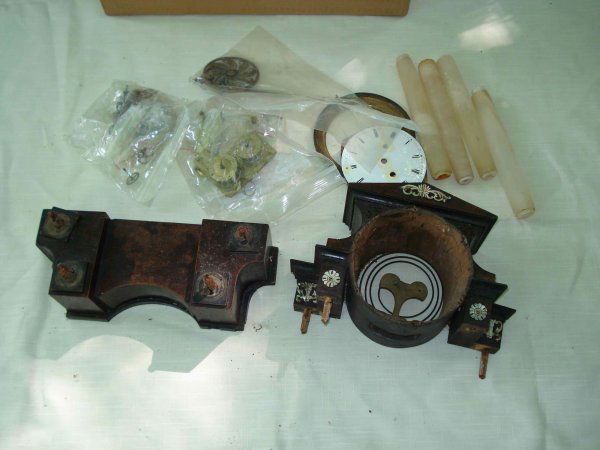 Austrian mantel clock disassembled: A disassembled Austrian pillar clock with white alabaster pillars, a round porcelain dial (damaged) and the original thirty hour clockworks.