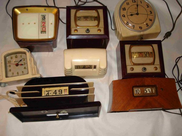 Assorted electric clocks : An assortment of about half dozen electric clocks including digit examples.