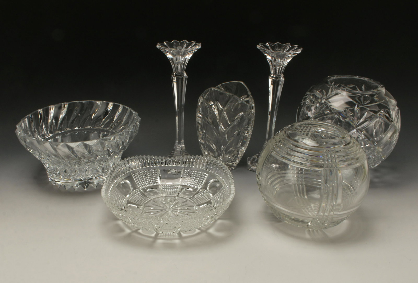 ASSEMBLED CUT CRYSTAL LOT: ASSEMBLED CUT CRYSTAL LOT9 items. Pair of candle sticks. Three vases and two bowls. Tw