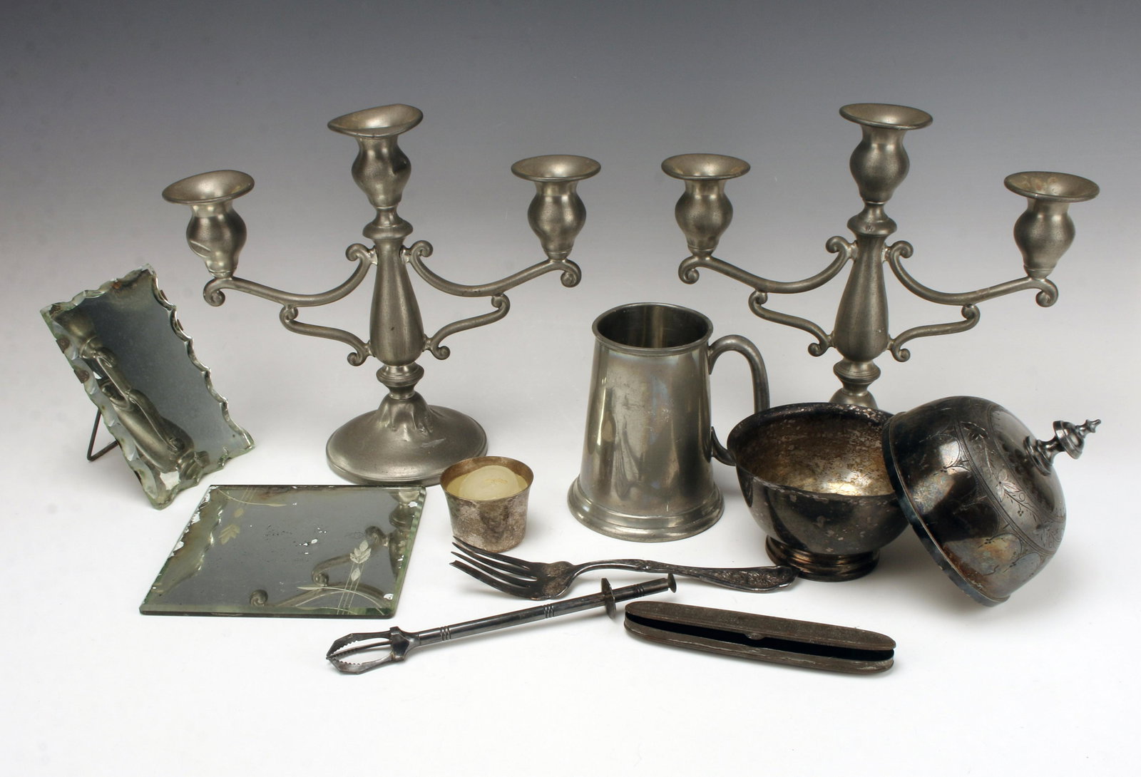 ANTIQUE PEWTER MIRROR LOT: ANTIQUE PEWTER MIRROR LOTPair of pewter candlesticks, one is bent. Decorative meat for