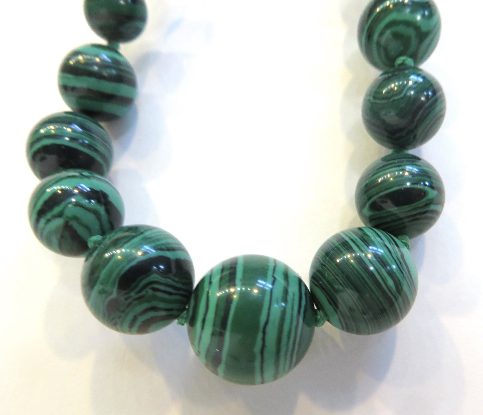 MALACHITE NECKLACE: MALACHITE NECKLACE	Graduated beads range in size from 5 mm - 14 mm., about 16"