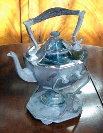 Teapot and warmer: Ebony and silver or silver plate 19th teapot, complete with cradle and warmer.