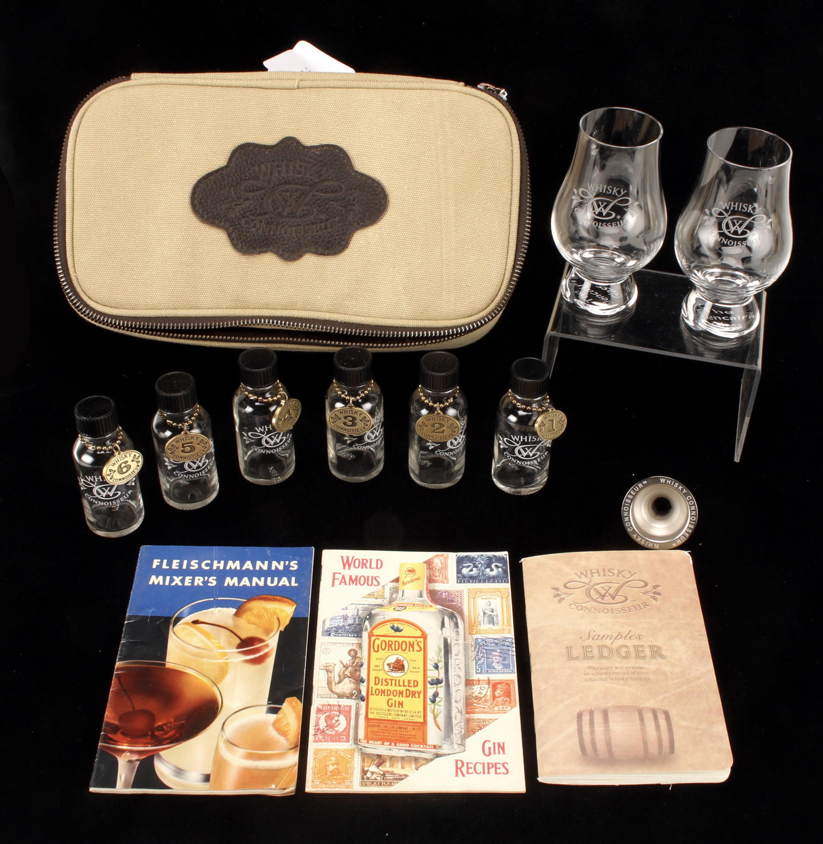 WHISKEY CONNOISSEUR TRAVEL SET: WHISKEY CONNOISSEUR TRAVEL SET Including two whisky snifters, two droppers funnel, and six small bottles. A ledger and recipe book in pocket of carrying case.