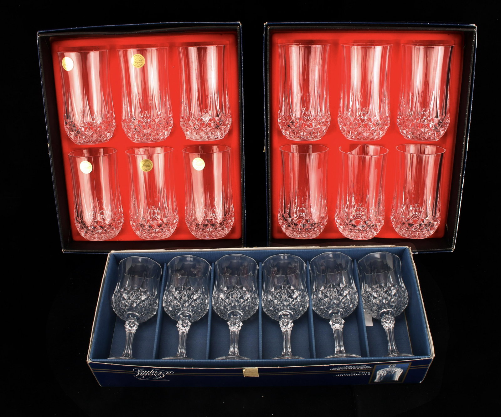 LONGCHAMP & CRISTAL D'ARC GLASSES NIB: LONGCHAMP & CRISTAL D'ARC GLASSES NIB Six wine glasses by Longchamp and and twelve Cristal D'Arc water glasses new in box . One box has damage. 17"