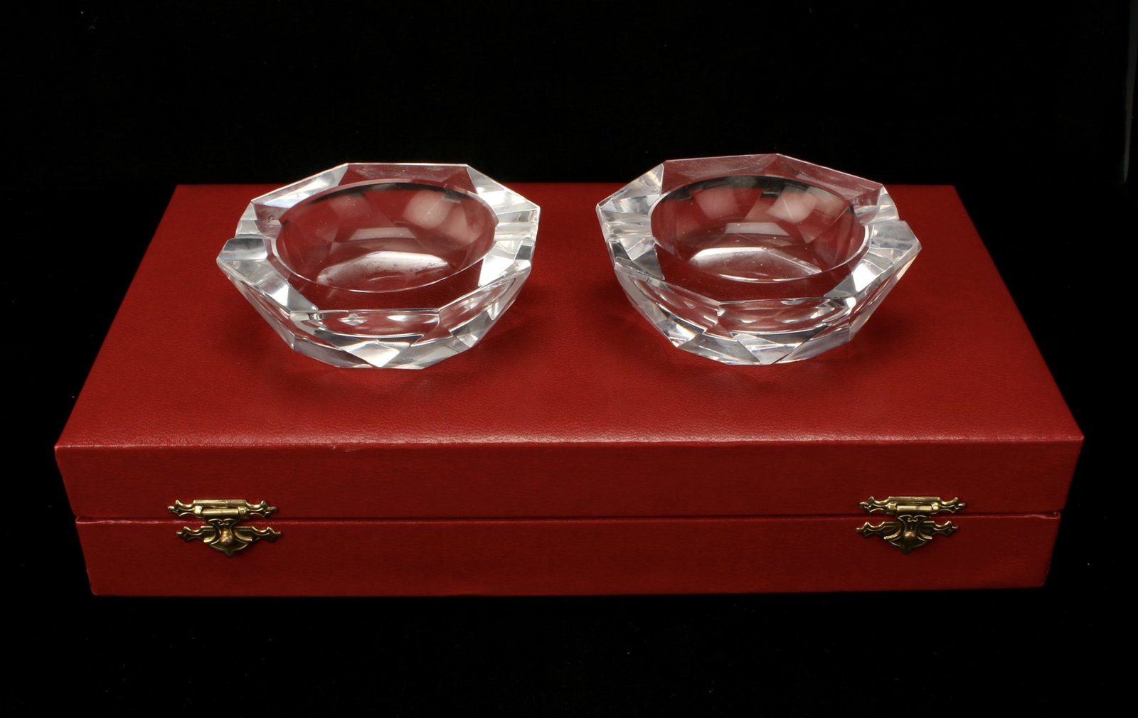CARTIER FACETED CRYSTAL OCTAGONAL ASHTRAYS IN BOX: CARTIER FACETED CRYSTAL OCTAGONAL ASHTRAYS IN BOX Signed on the bottom, in red Cartier box. 9 1/2" X 5 1/4" $100 - $