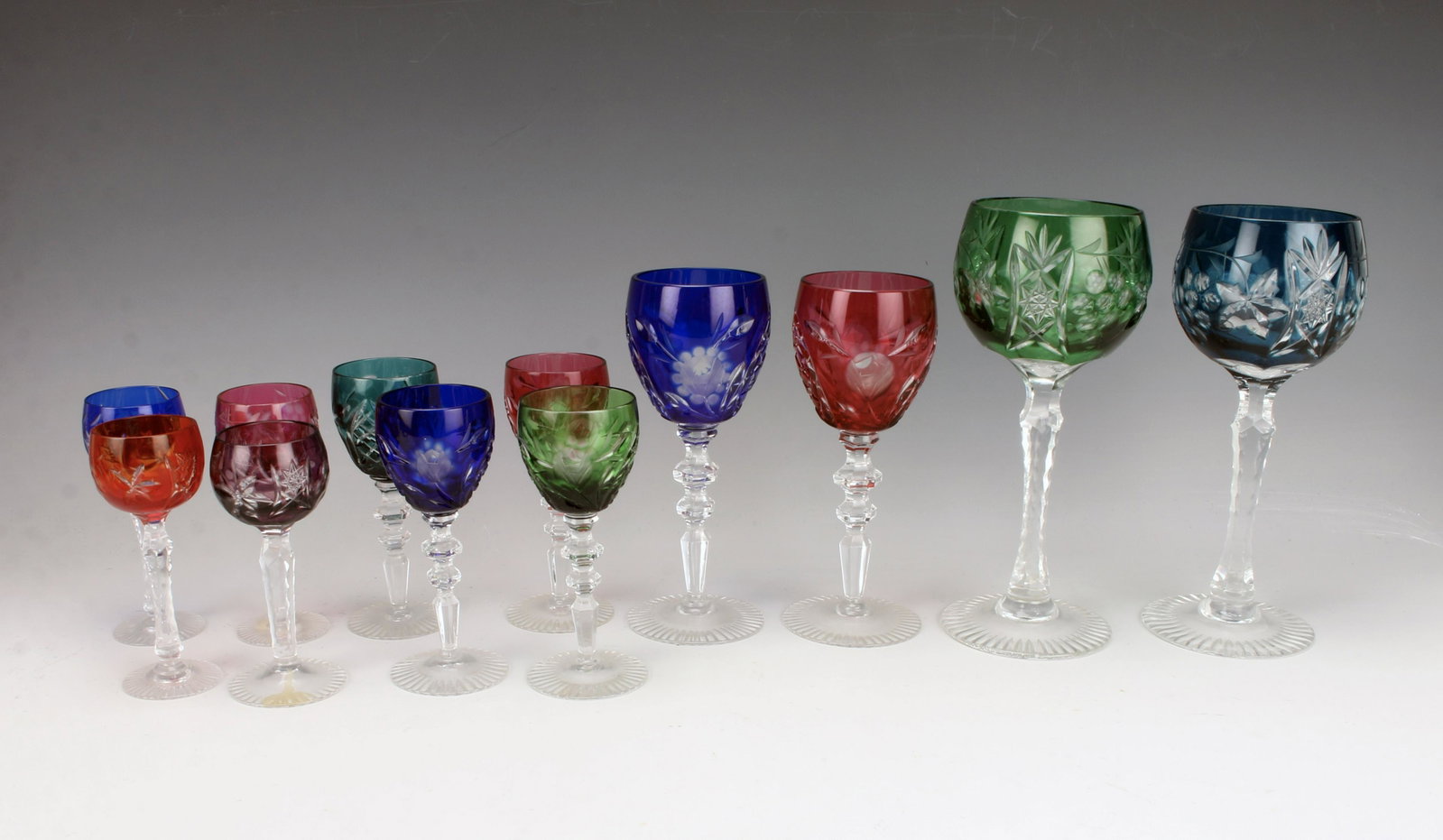 BOHEMIAN MULTICOLOR CUT TO CLEAR CRYSTAL GLASSES: BOHEMIAN MULTICOLOR CUT TO CLEAR CRYSTAL GLASSES 4 small round cordial glasses, 4 taller cordial glasses, 2 white wine glasses, 2 red wine glasses. In jewel tone colors, cut to clear in
