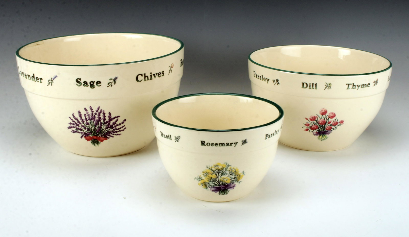 VINTAGE PORTUGAL HERB THEME NESTING BOWLS: VINTAGE PORTUGAL HERB THEME NESTING BOWLS Each bowl has three flowering bouquets and bordered by the names of spices next to a sprig. Largest bowl has a crack, and has been attempted to