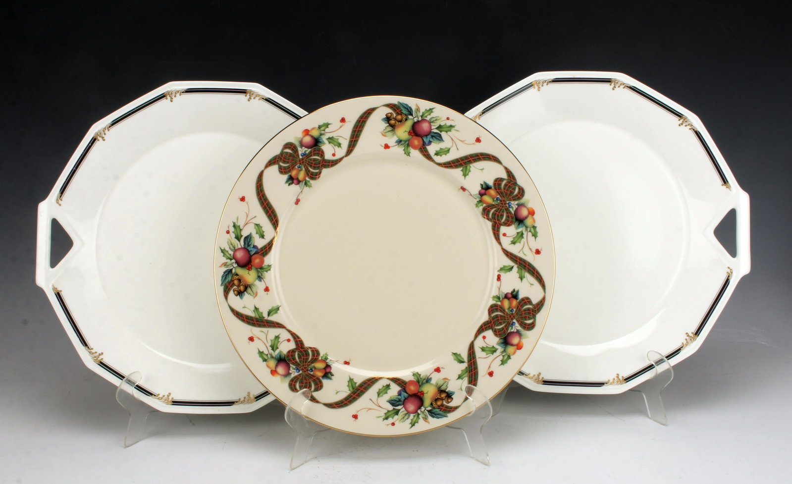 MIKASA GOLDEN SURF & LENOX HOLIDAY TARTAN PLATTERS: MIKASA GOLDEN SURF & LENOX HOLIDAY TARTAN PLATTERS Two matching Mikassa Golden Surf art deco style 13" cake/ charger plates with handles and one Lenox 12" Holiday Tartan ro