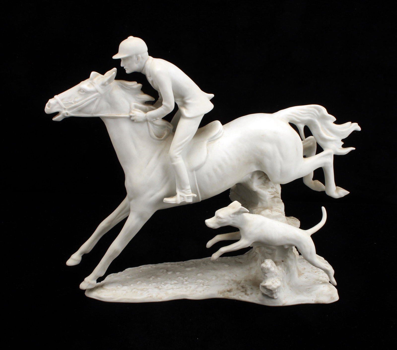KAISER W GERMANY BISQUE FOX HUNT FIGURE: KAISER W GERMANY BISQUE FOX HUNT FIGURE West German Kaiser bisque porcelain fox hunt figure with hound, horse, and hunter. 10" X 9"