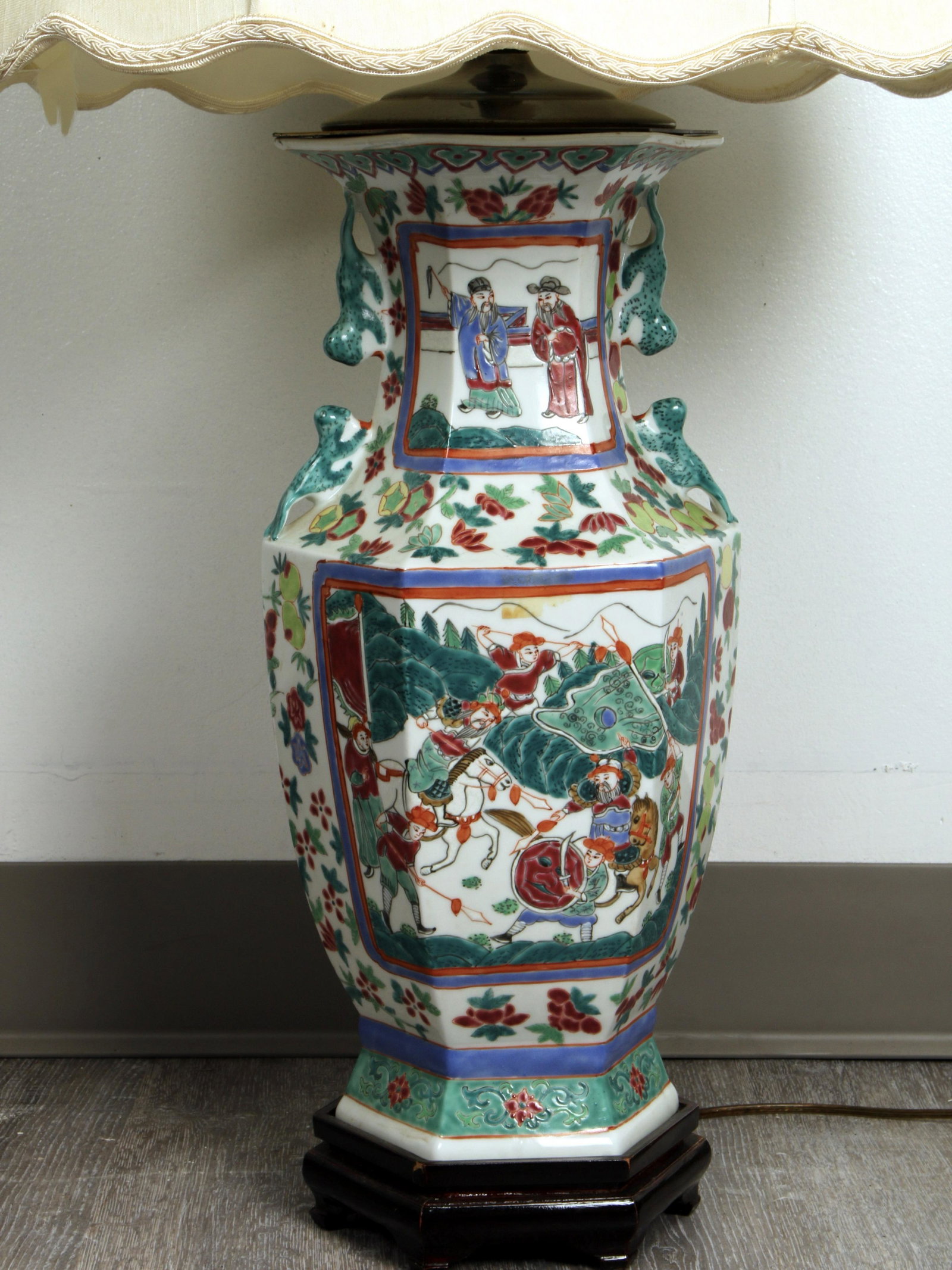 CHINESE STYLE HEXAGONAL SCENIC PORCELAIN LAMP: CHINESE STYLE HEXAGONAL SCENIC PORCELAIN LAMP On wooden base. Foo dog handles. Custom shade, interior of shade is ripped. 34 1/2" x 7"