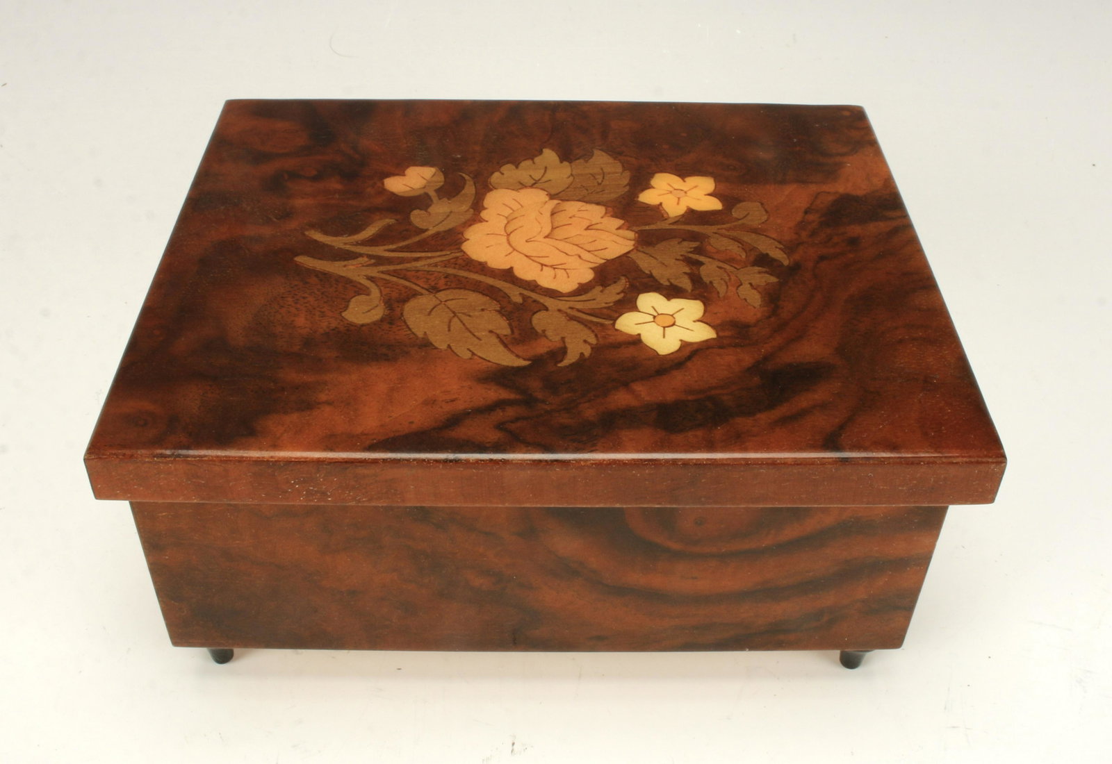 REUGE MUSIC BOX GODFATHER: REUGE MUSIC BOX GODFATHER Wooden music box that plays music when lid is open. Lid decorated with flowers. Marked Reuge with Swiss musical movement. Made in Italy.