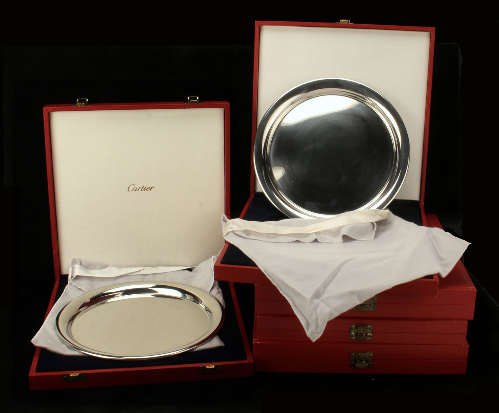 5 CARTIER POLISHED PEWTER CHARGERS: 5 CARTIER POLISHED PEWTER CHARGERS 5 Cartier highly polished pewter chargers in original red Cartier boxes, all marked on bottom "Cartier Pewter". 4 come with original Cartier