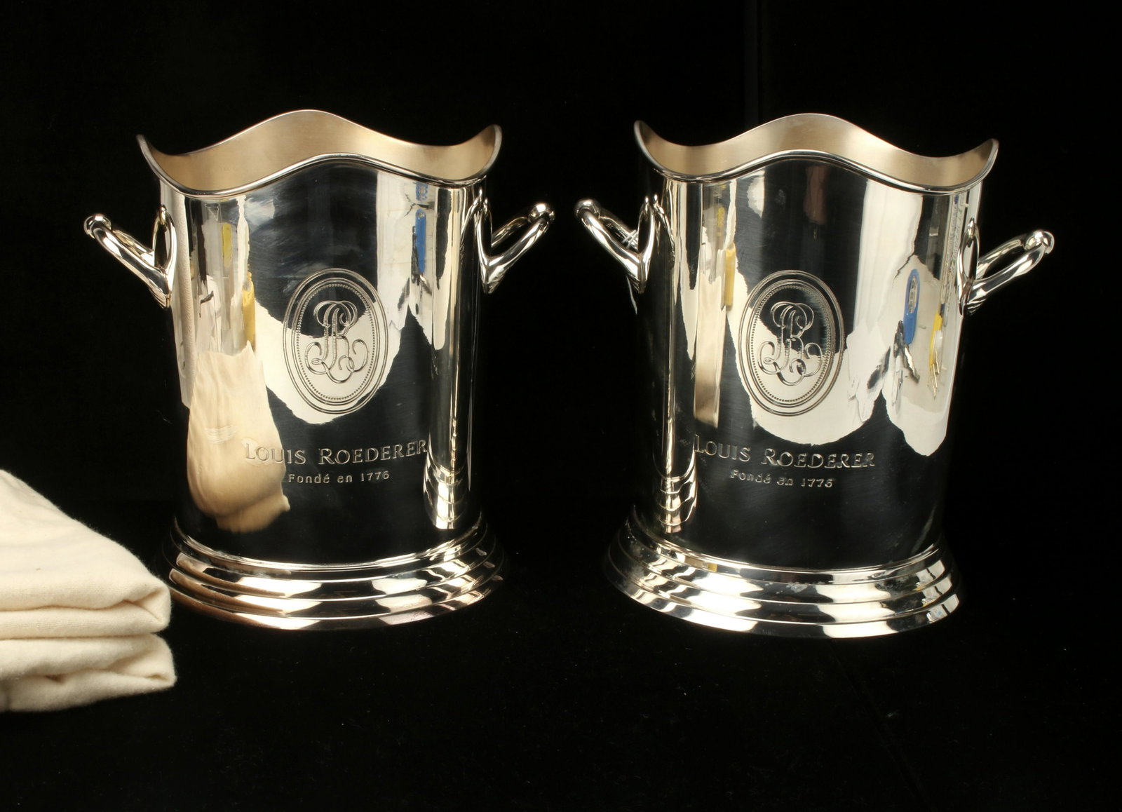 TWO ROEDERER CHAMPAGNE WINE COOLER ICE BUCKETS: TWO ROEDERER CHAMPAGNE WINE COOLER ICE BUCKETS With two chamois storage bags. Logo is on both sides. Marked Made in India. 9 1/2" X 9 1/2"