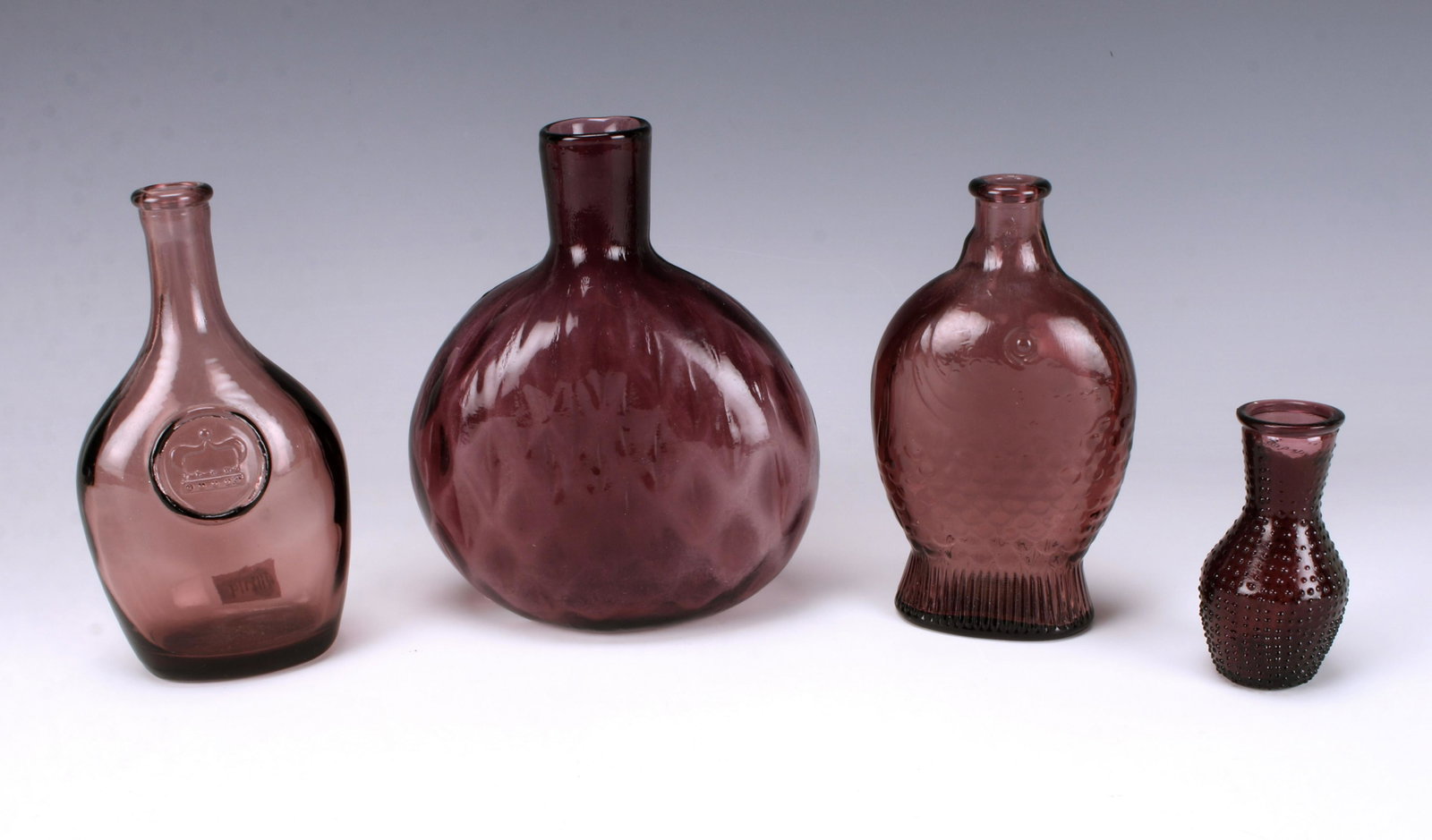 PURPLE GLASS ARTIFACTS FROM LUCY EVELYN SHIP: PURPLE GLASS ARTIFACTS FROM LUCY EVELYN SHIP Beautiful eggplant purple glass bottles in various shapes and patterns from the Lucy Evelyn Ship. 6" x 5&q