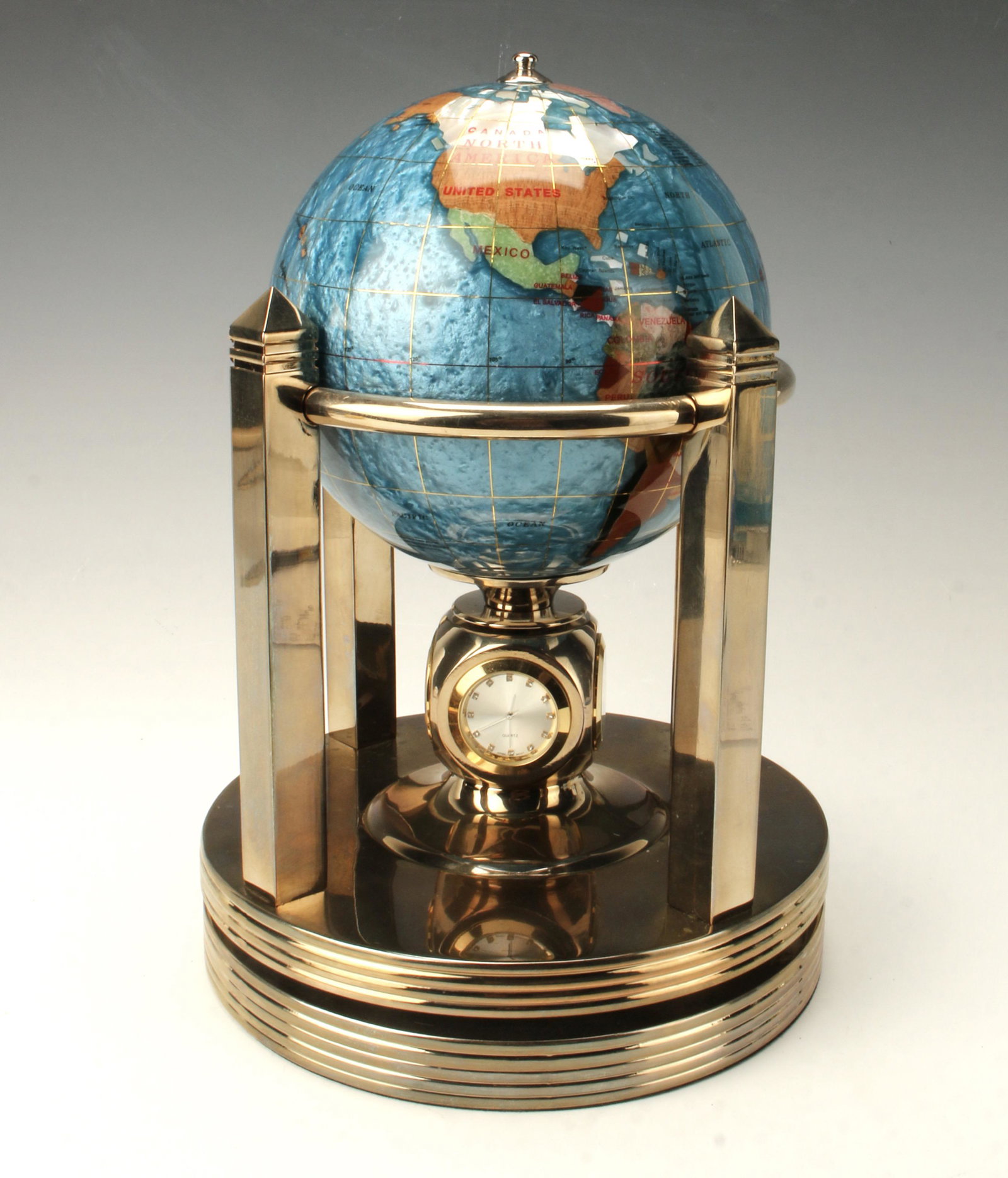 REVOLVING GLOBE CLOCK THERMOMETER HYDROMETER: REVOLVING GLOBE CLOCK THERMOMETER HYDROMETER Two clock faces, thermometer and hydrometer. Quartz clock, movement is made in Japan. Globe is inlaid with various colorful stones and resin