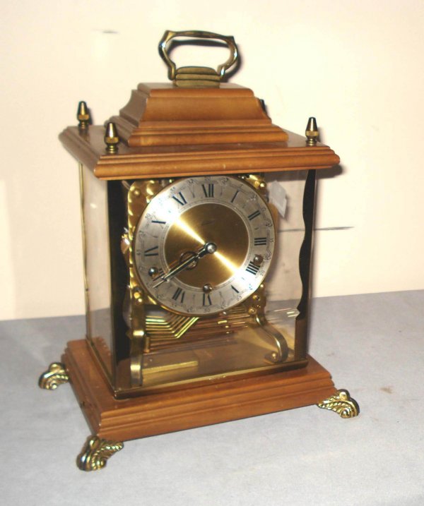 Mantel Clock : A 20th century mantel clock whose glass case allows for viewing the Westminster chime. Made by Schatz, a German clockmaker.