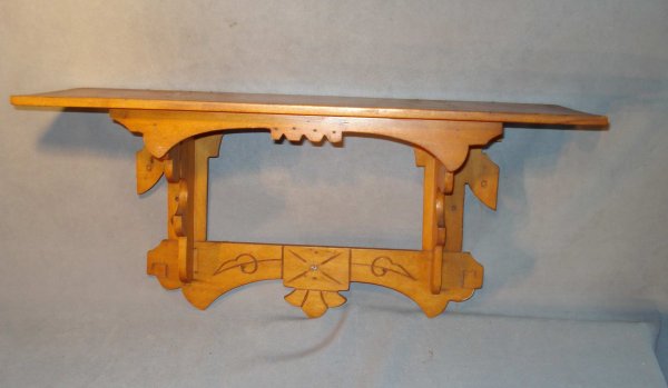 Clock Shelf of Faded Wood : A clock shelf with incised decoration and faded wood.