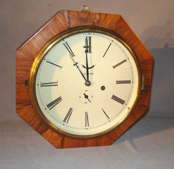 Octagon "Locomotive" Clock by Jerome: An octagon shaped wall clock, 12" across, of mahogany or rosewood veneer with a round dial. The restored dial is inscribed "C. Jerome".