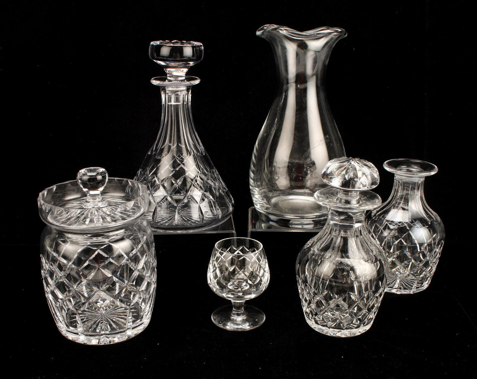 CARTIER CRYSTAL BAR SERVICE ITEMS, CANISTERS: CARTIER CRYSTAL BAR SERVICE ITEMS, CANISTERS 1 Wine decanter, 3 cut crystal decanters (1 missing stopper), 1 small snifter, 1 cannisters with lid. All marked Cartier.