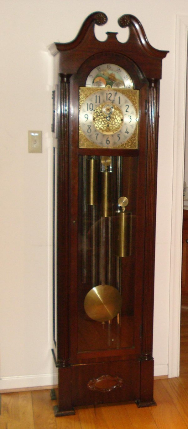 Herschede Chime Hall Clock: A 79" mahogany cased hall clock manufactured by the Herschede Clock Co., having four tubular bell chimes and a gold, silvered and painted moon dial.