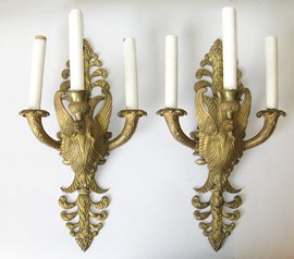 Swan theme Ormolu Sconces: A pair of 17" cast ormolu swan form sconces, each accommodating three lights. Wired for electricity.